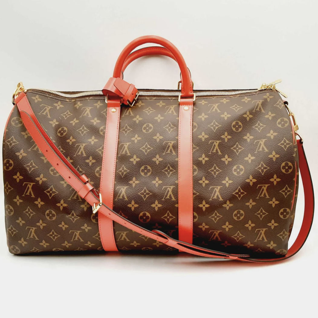 A Louis Vuitton designer handbag with a brown and tan monogram pattern featuring leather handles and a shoulder strap.