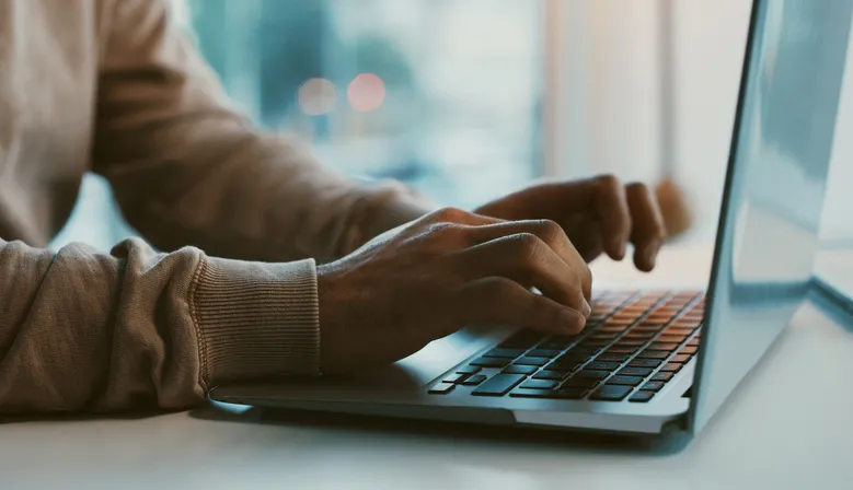 A man typing on a computer.